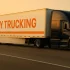wny trucking semi truck with large orange wny trucking logo on white trailer showing fast on time drayage delivery near buffalo ny