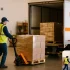 Professional warehouse handler moving a pallet toward a WNY Trucking trailer for less than truckload shipping.