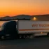 WNY TRUCKING refrigerated semi-truck driving at sunset representing reliable on-time cold-chain deliveries