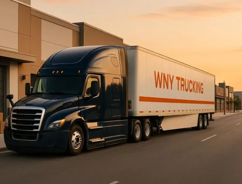 WNY Trucking dark navy semi truck with white trailer and orange stripe leaving a retail loading dock in Buffalo NY, illustrating reliable local last mile delivery service